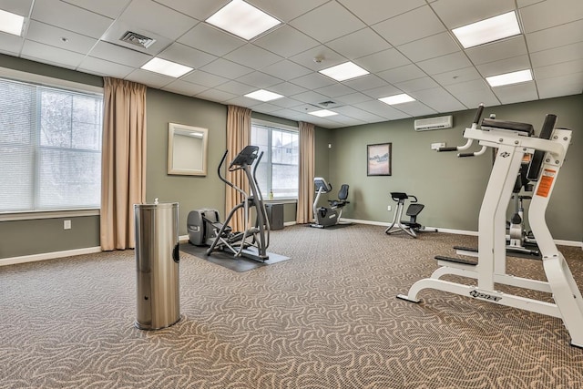 gym featuring carpet, a drop ceiling, and plenty of natural light