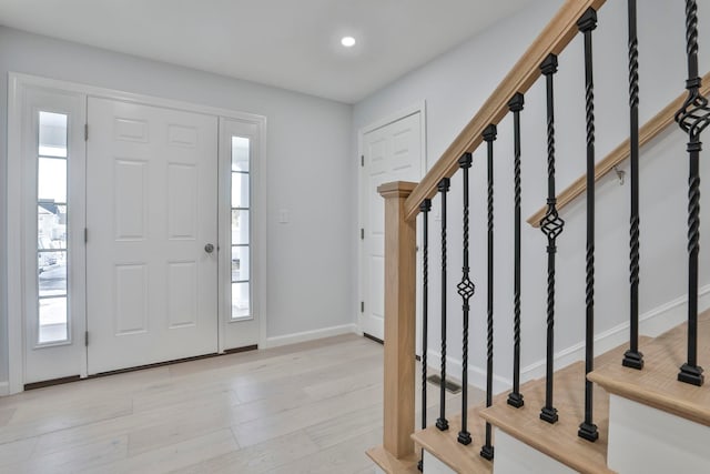 foyer with a healthy amount of sunlight and light hardwood / wood-style floors