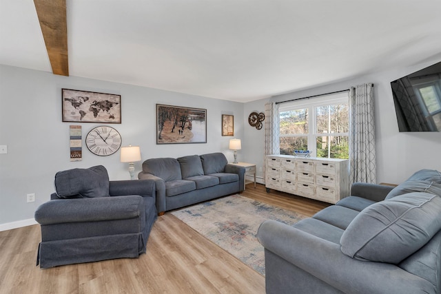 living room with beamed ceiling and wood-type flooring