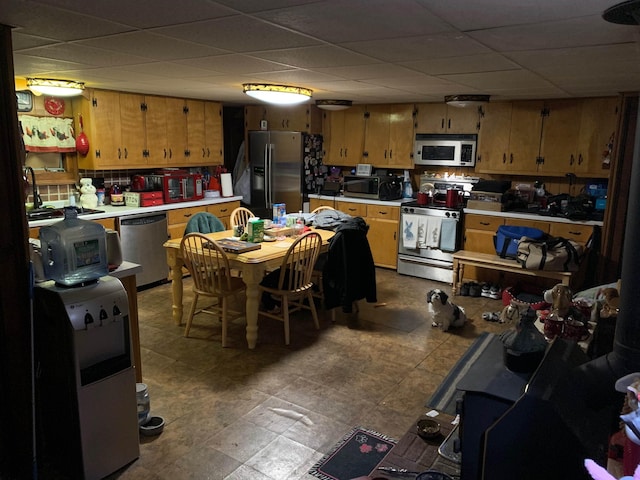 kitchen with a drop ceiling and stainless steel appliances