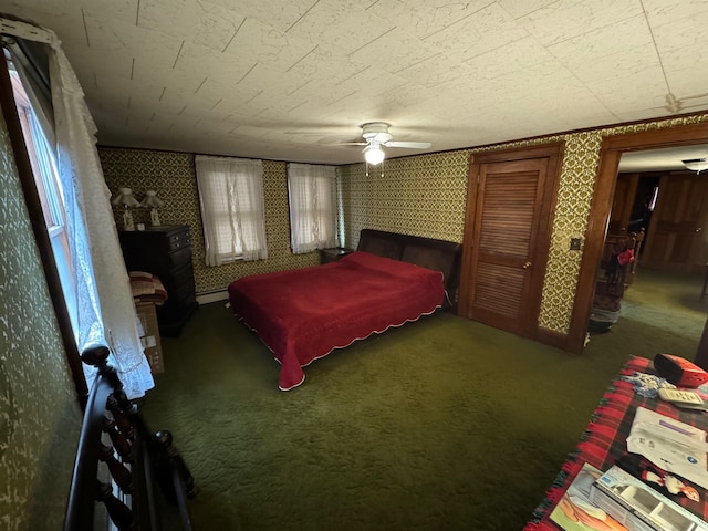 bedroom featuring dark colored carpet and ceiling fan