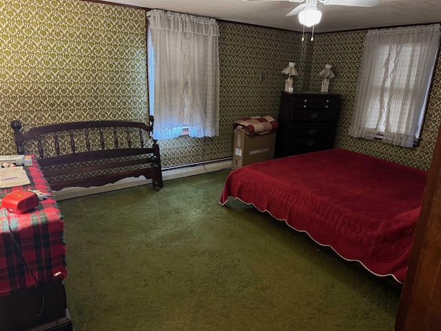 carpeted bedroom featuring baseboard heating and ceiling fan