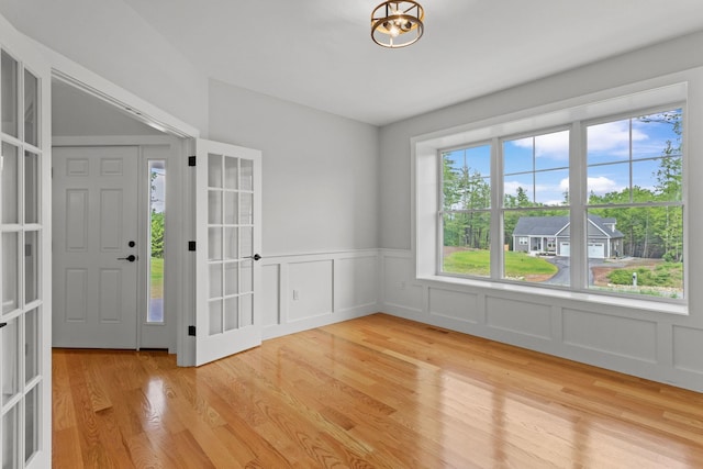 foyer entrance with french doors and light wood-type flooring