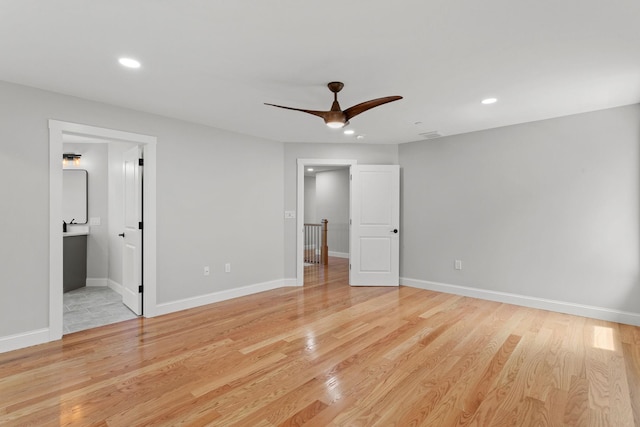 unfurnished bedroom featuring connected bathroom, ceiling fan, and light hardwood / wood-style floors