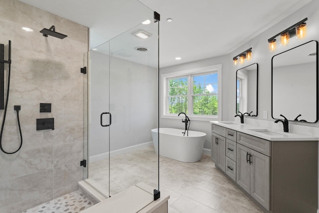 bathroom featuring tile patterned flooring, vanity, and shower with separate bathtub