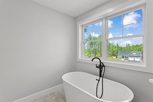 bathroom featuring tile patterned flooring and a bath