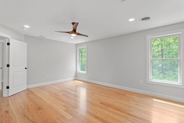 spare room featuring light hardwood / wood-style flooring and ceiling fan