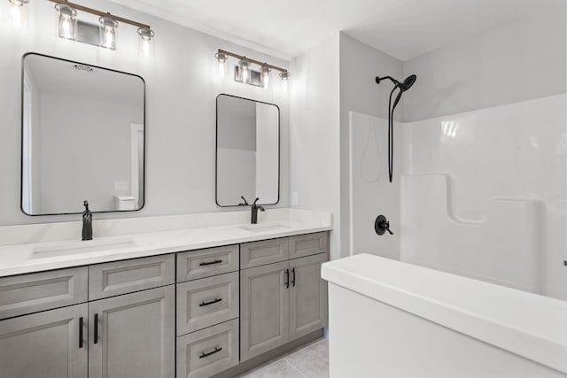 bathroom featuring tile patterned floors, vanity, and a shower