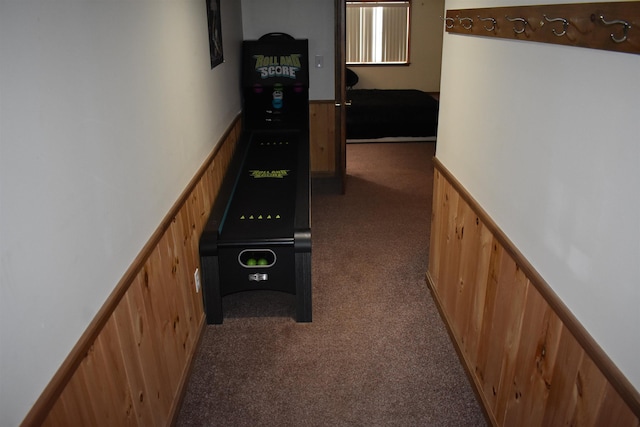 corridor with dark carpet and wooden walls