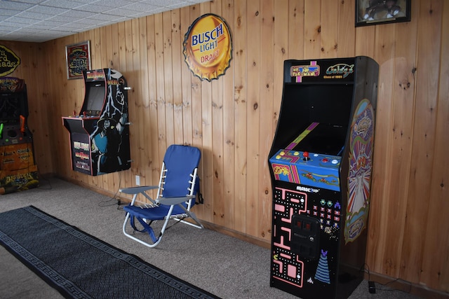 recreation room featuring carpet floors and wood walls