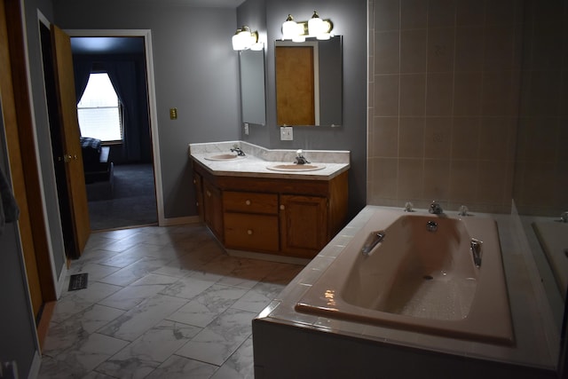 bathroom with vanity and a relaxing tiled tub