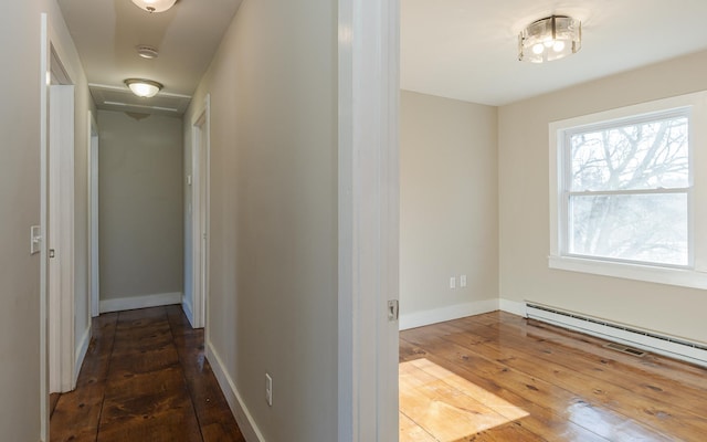 corridor featuring dark hardwood / wood-style flooring and baseboard heating