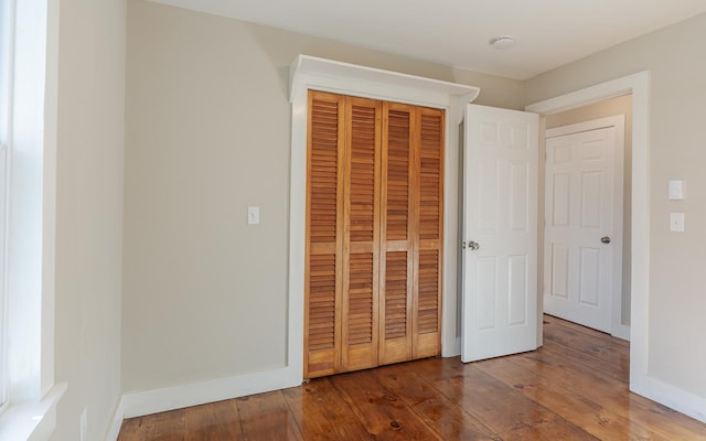 unfurnished bedroom with hardwood / wood-style flooring