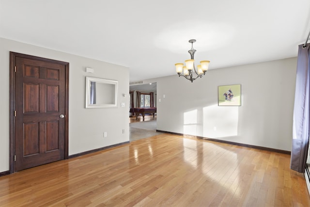 interior space featuring pool table, a notable chandelier, and light wood-type flooring