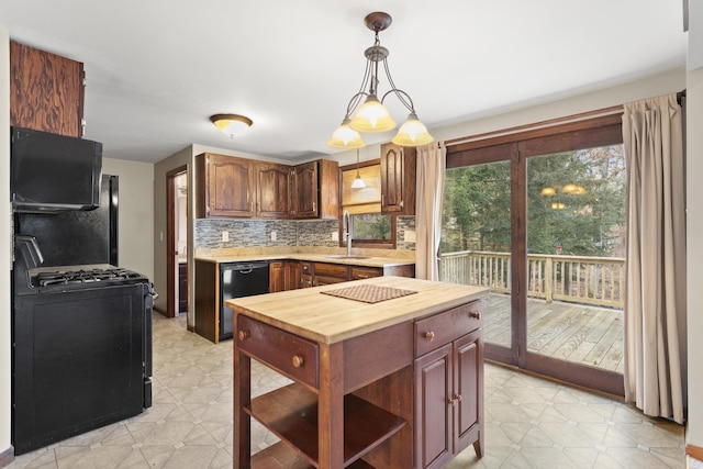 kitchen with hanging light fixtures, tasteful backsplash, plenty of natural light, and black appliances