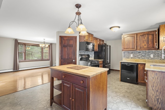 kitchen featuring black appliances, backsplash, hanging light fixtures, and an inviting chandelier