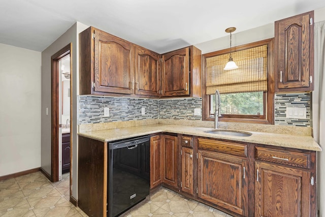 kitchen featuring light stone countertops, sink, black dishwasher, backsplash, and pendant lighting