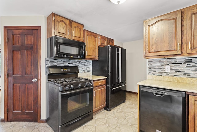 kitchen with black appliances and decorative backsplash