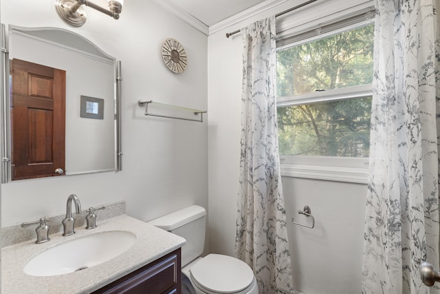 bathroom featuring a shower with shower curtain, vanity, toilet, and crown molding