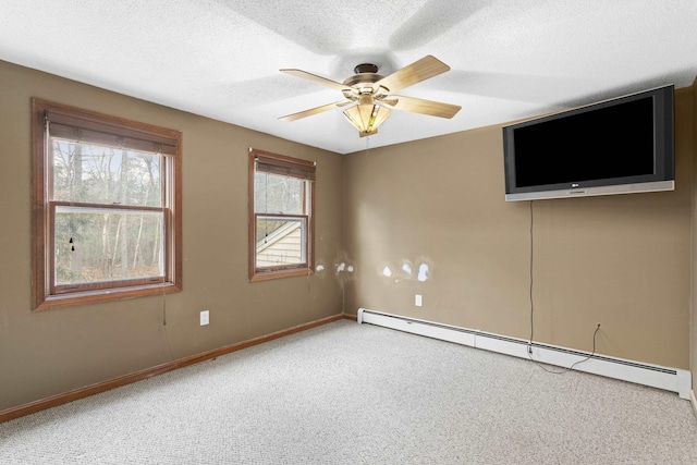 carpeted spare room featuring a textured ceiling, baseboard heating, and ceiling fan