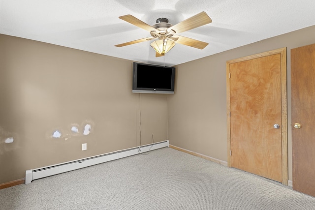 unfurnished bedroom featuring ceiling fan, carpet, and a baseboard radiator