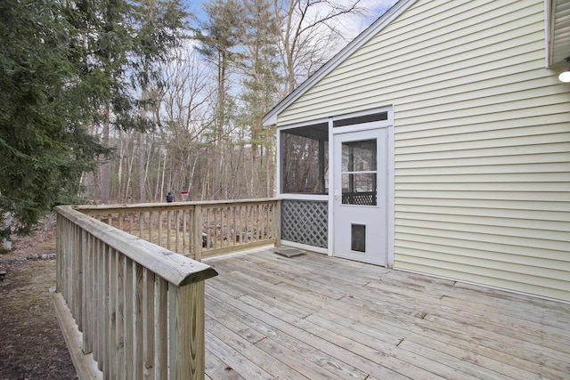 wooden deck with a sunroom