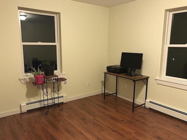 office area featuring baseboard heating and dark hardwood / wood-style flooring