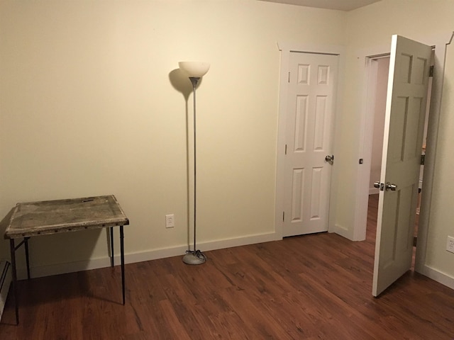 misc room with dark hardwood / wood-style flooring and a baseboard heating unit