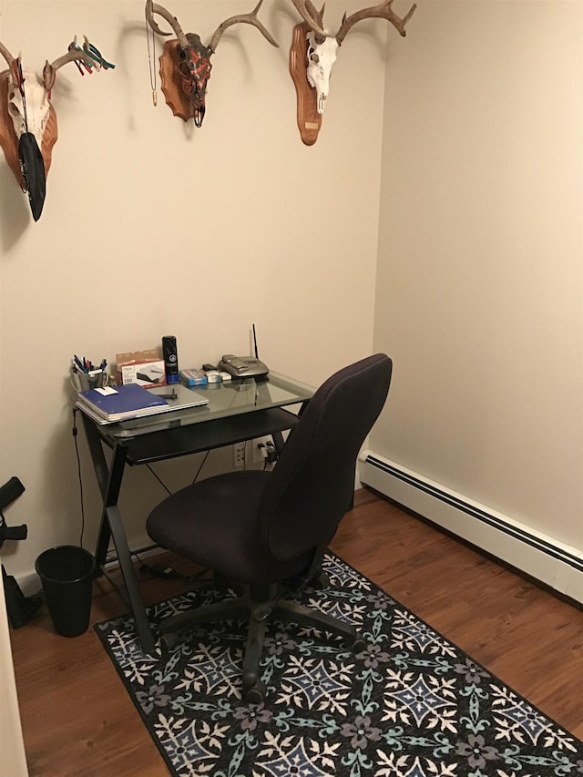 office area featuring baseboard heating and wood-type flooring