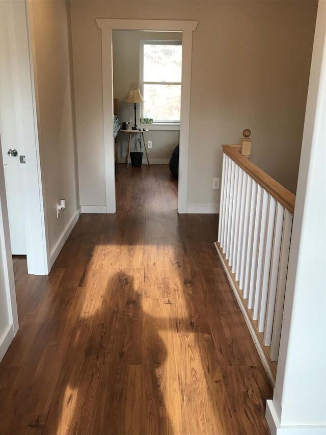 hallway with dark hardwood / wood-style floors