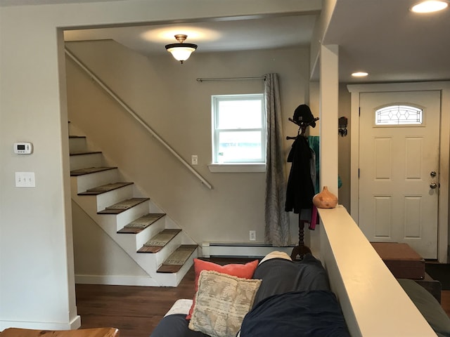 foyer entrance with dark hardwood / wood-style flooring and a baseboard heating unit