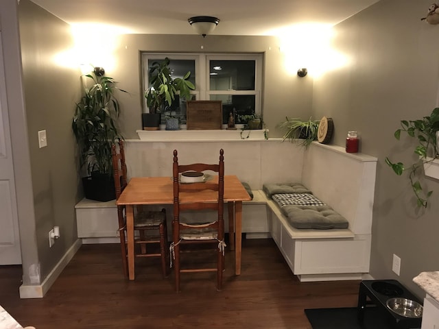 dining space featuring breakfast area and dark hardwood / wood-style floors