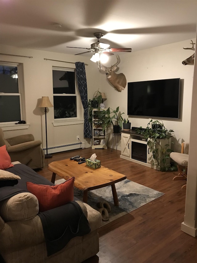 living room featuring ceiling fan, baseboard heating, and wood-type flooring