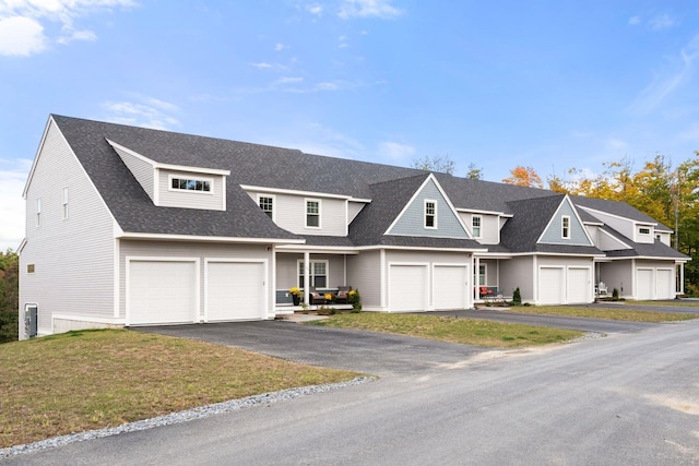 view of front of property with a front lawn and a garage