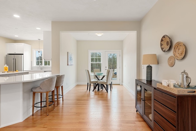 dining room with french doors and light wood-type flooring