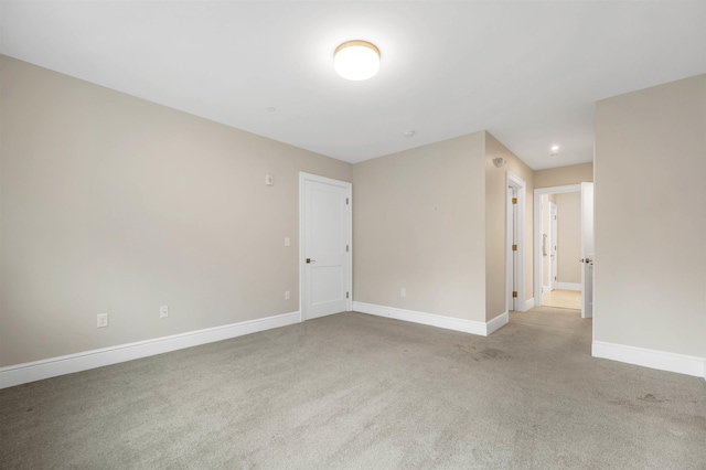 unfurnished room with light colored carpet