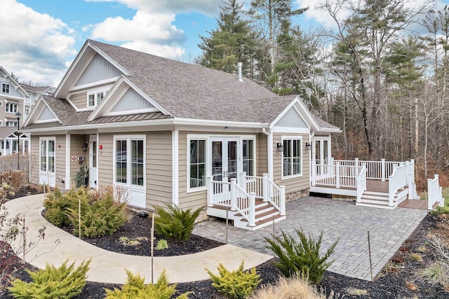 view of front of house with french doors, a patio, and a deck