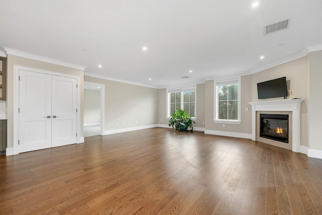 unfurnished living room featuring dark hardwood / wood-style floors and crown molding