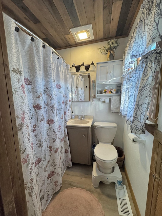 bathroom with hardwood / wood-style floors, vanity, a shower with shower curtain, toilet, and wood ceiling