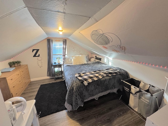 bedroom with lofted ceiling and wood-type flooring