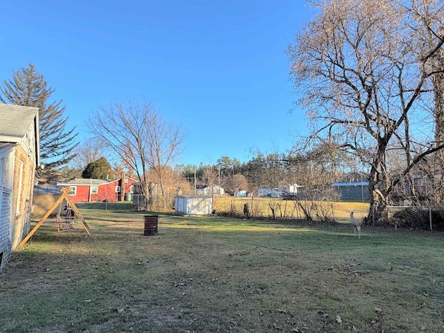 view of yard featuring a playground and a shed