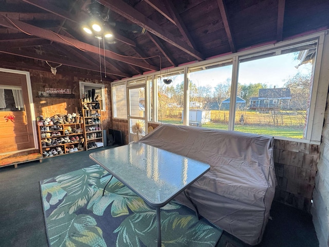 unfurnished sunroom with plenty of natural light and vaulted ceiling