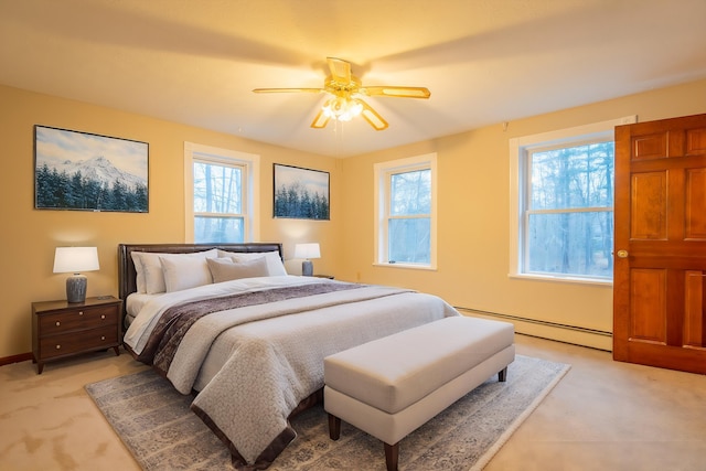 bedroom with light carpet, baseboard heating, and ceiling fan