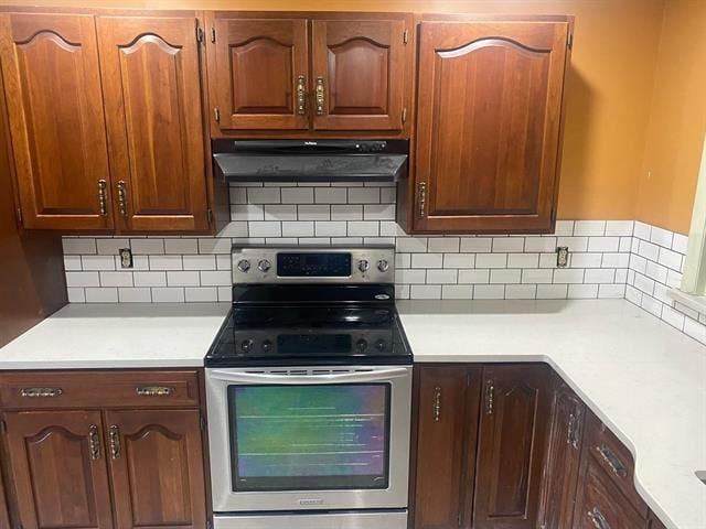 kitchen with stainless steel range with electric stovetop and backsplash