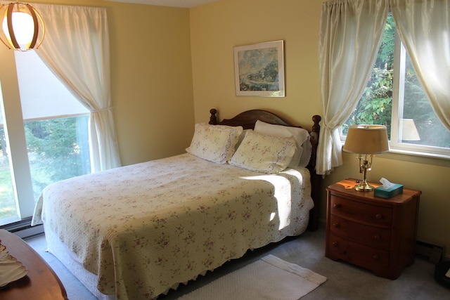 carpeted bedroom with baseboard heating