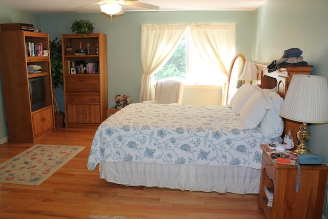 bedroom with ceiling fan and light hardwood / wood-style floors