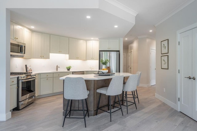 kitchen with white cabinets, light wood-type flooring, a center island, and stainless steel appliances