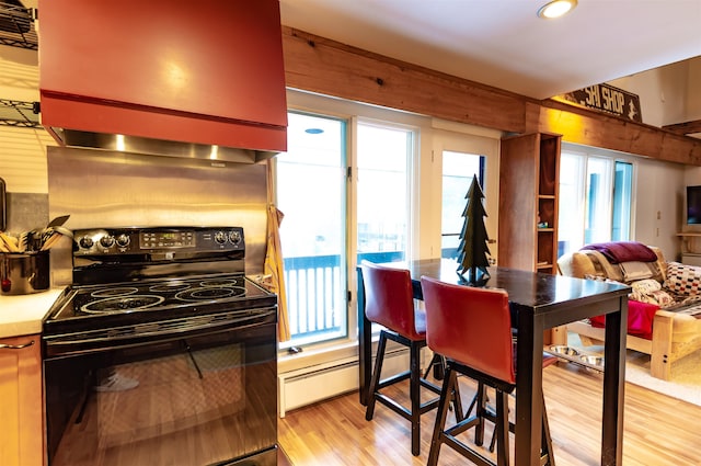 kitchen featuring ventilation hood, light hardwood / wood-style floors, black range with electric stovetop, and a baseboard heating unit