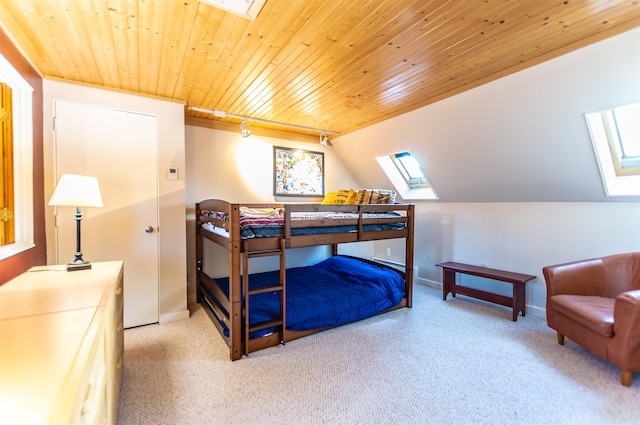 carpeted bedroom featuring wooden ceiling and lofted ceiling with skylight