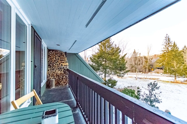 view of snow covered back of property